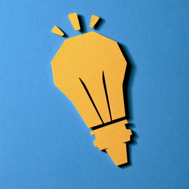 Cut-paper lightbulb brand illustration